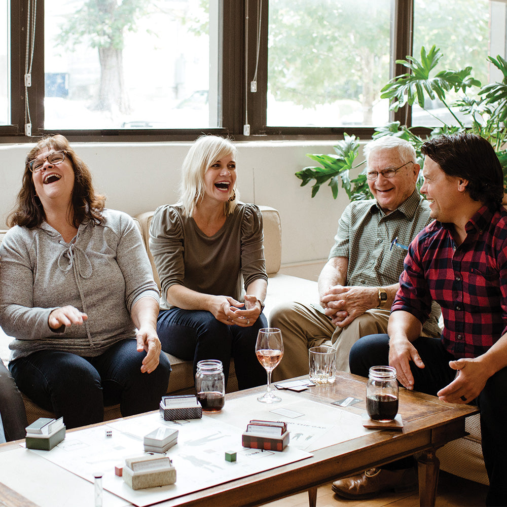 A Boomer, Gen X, Millennial, and Gen Z playing Mind the Gap and laughing with each of the generations.