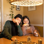 Two people laughing while playing an amazing board game from SolidRoots.